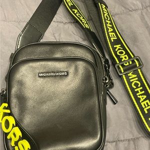 Black and neon green logo tape Michael Kors crossbody.